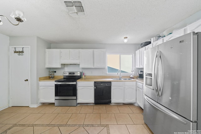 kitchen with stainless steel appliances, sink, a textured ceiling, and white cabinets