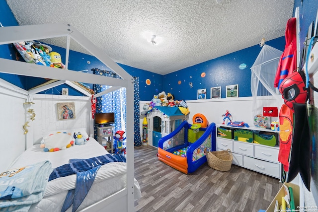 bedroom featuring hardwood / wood-style flooring and a textured ceiling