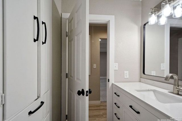 bathroom with hardwood / wood-style flooring and vanity