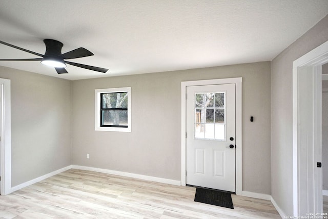 foyer featuring ceiling fan, plenty of natural light, and light hardwood / wood-style floors