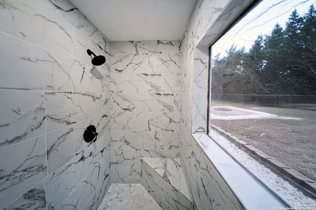 interior details with a tile shower