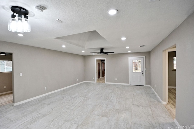 empty room featuring ceiling fan and a textured ceiling