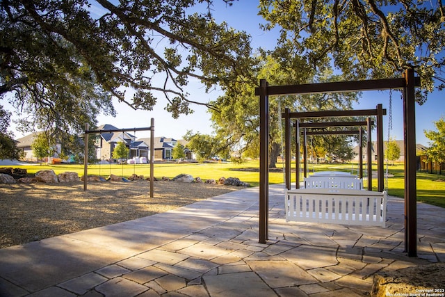 view of community featuring a hot tub and a lawn