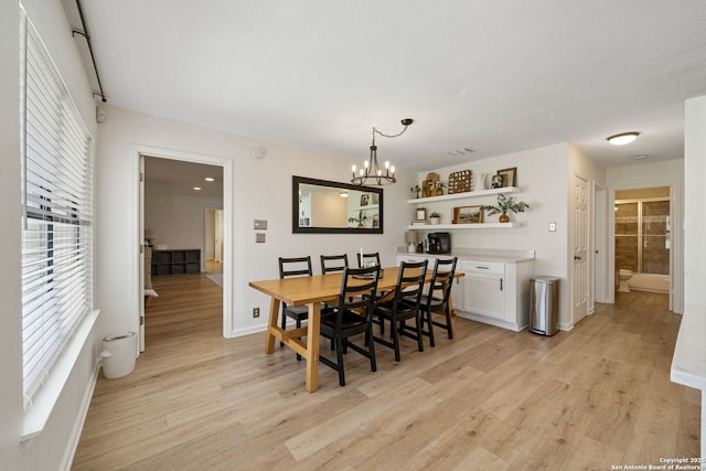 dining room featuring light hardwood / wood-style floors and a chandelier