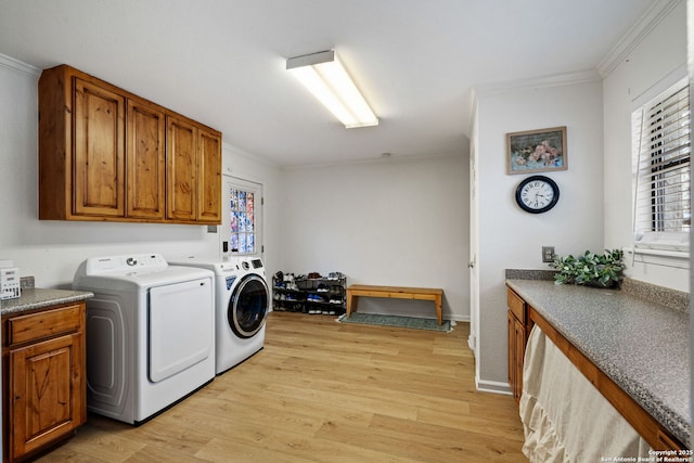 washroom with cabinets, ornamental molding, independent washer and dryer, and light wood-type flooring