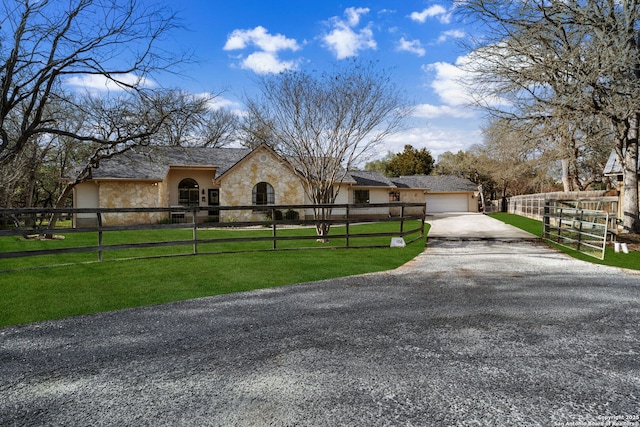 view of front of home with a garage and a front lawn