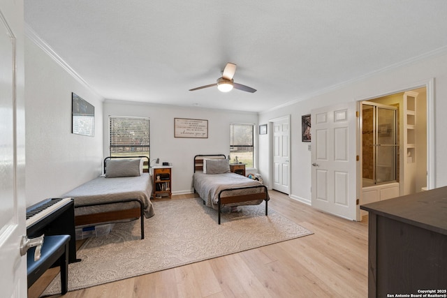 bedroom featuring crown molding, ensuite bath, light hardwood / wood-style floors, and ceiling fan