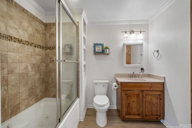 full bathroom with wood-type flooring, crown molding, bath / shower combo with glass door, and toilet