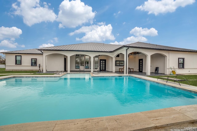 view of pool featuring ceiling fan and a patio area