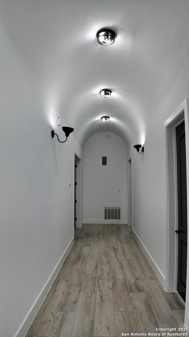 corridor with light hardwood / wood-style flooring