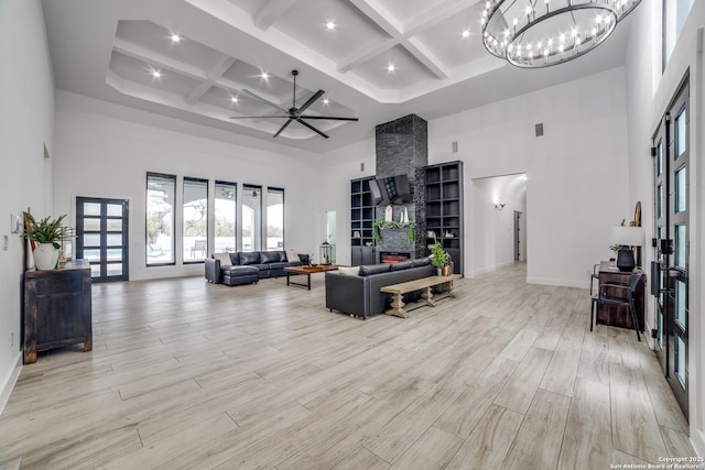 living room featuring coffered ceiling, beam ceiling, and a high ceiling