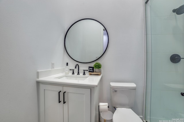 bathroom with vanity, walk in shower, and toilet