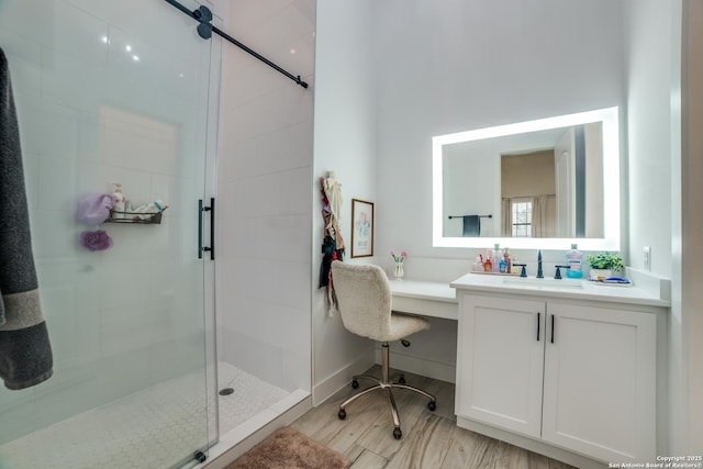 bathroom with vanity and a shower with shower door