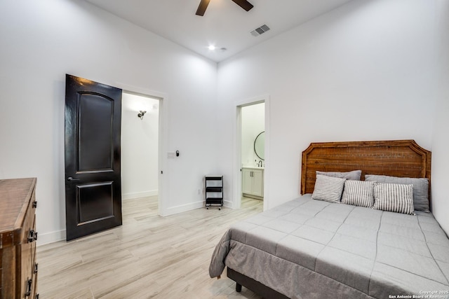 bedroom with ceiling fan, ensuite bathroom, light hardwood / wood-style floors, and high vaulted ceiling