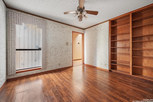 spare room featuring hardwood / wood-style flooring, crown molding, a textured ceiling, and ceiling fan