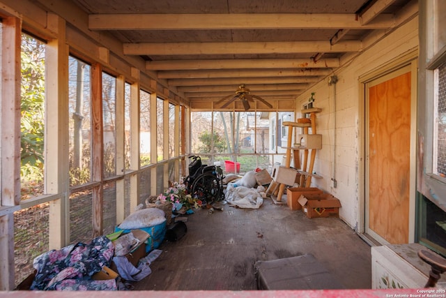 unfurnished sunroom with beam ceiling