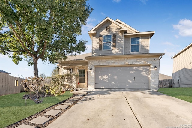 view of front of house featuring a garage and a front lawn