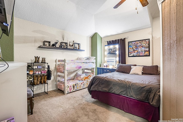 bedroom featuring vaulted ceiling, light colored carpet, a textured ceiling, and ceiling fan