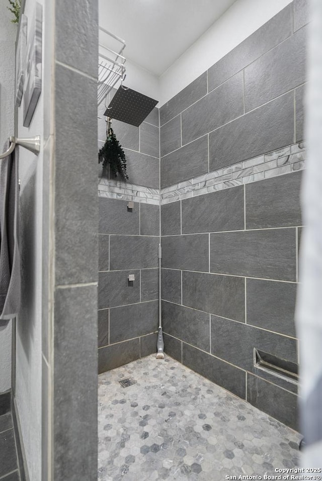 bathroom with a tile shower