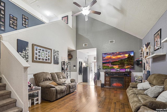 living room featuring ceiling fan, wood-type flooring, and high vaulted ceiling