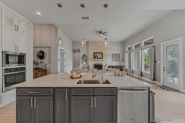 kitchen featuring white cabinetry, sink, gray cabinets, and stainless steel appliances