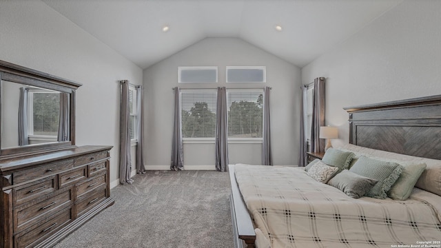 carpeted bedroom with lofted ceiling