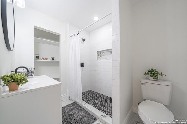 bathroom with vanity, a shower with shower curtain, and toilet