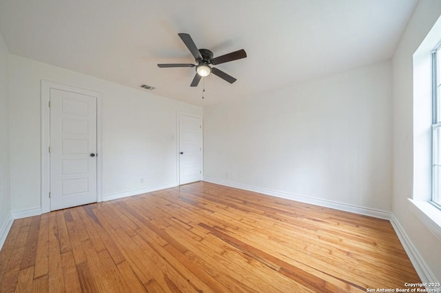 empty room with light hardwood / wood-style floors and ceiling fan