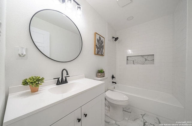 full bathroom with vanity, tiled shower / bath, and toilet