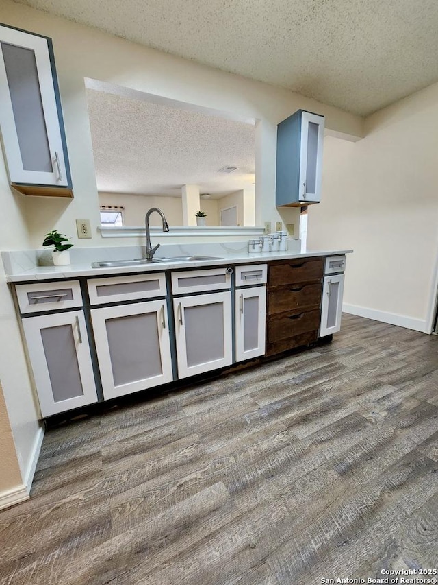 kitchen featuring sink and a textured ceiling