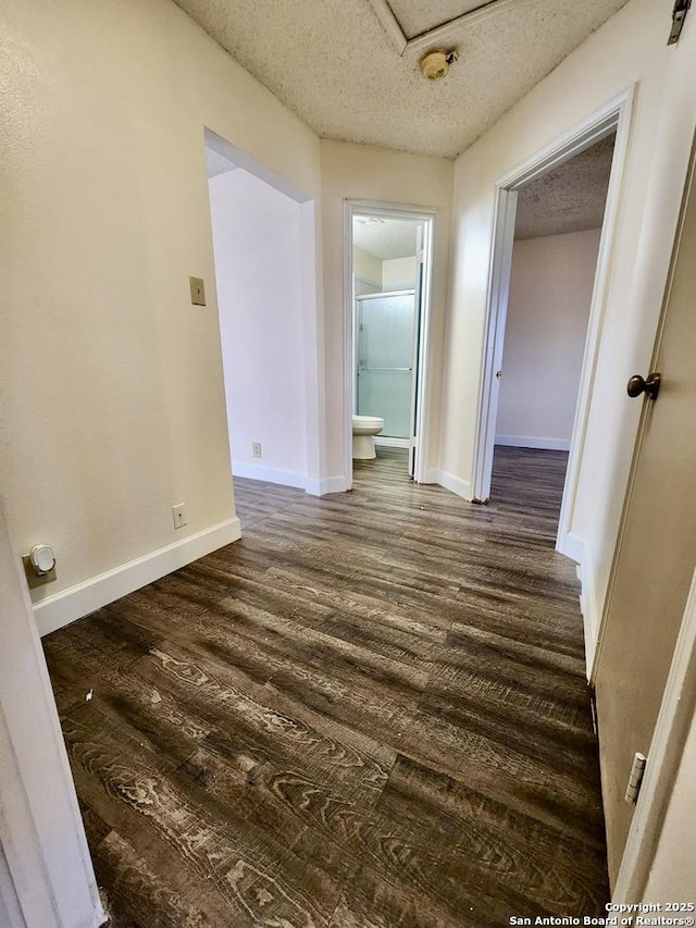 interior space featuring dark wood-type flooring and a textured ceiling