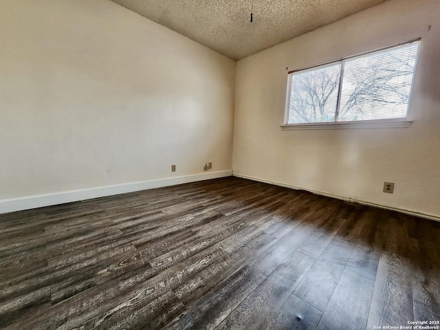 unfurnished room featuring dark hardwood / wood-style floors and a textured ceiling