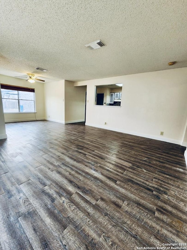 interior space featuring dark wood-type flooring, ceiling fan, and a textured ceiling