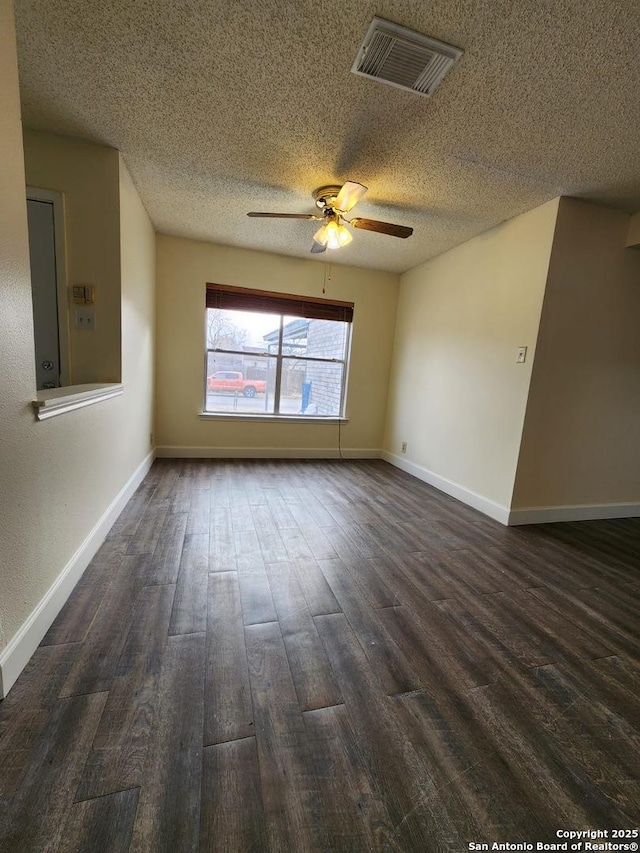 unfurnished room featuring dark hardwood / wood-style floors, a textured ceiling, and ceiling fan