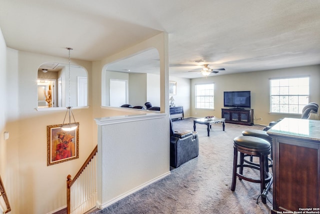 carpeted living room featuring ceiling fan