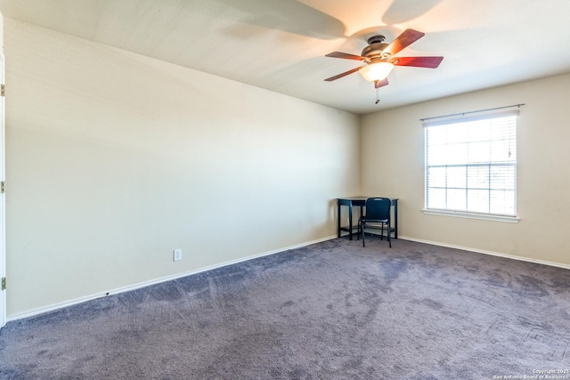 carpeted spare room featuring ceiling fan