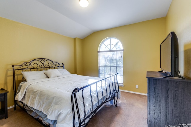 bedroom with lofted ceiling and dark colored carpet