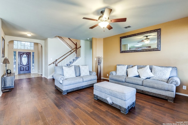 living room featuring ceiling fan and dark hardwood / wood-style floors