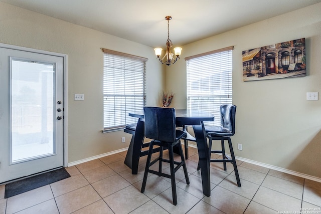 dining space featuring an inviting chandelier and light tile patterned floors