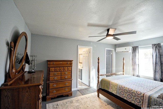 bedroom with a wall mounted air conditioner, a textured ceiling, ceiling fan, and ensuite bathroom