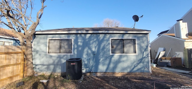 back of house featuring central air condition unit