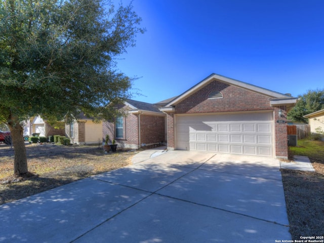 ranch-style home featuring cooling unit and a garage