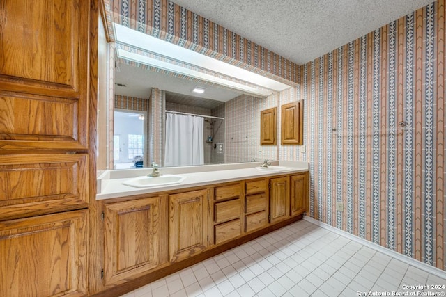 bathroom featuring vanity, a textured ceiling, and walk in shower