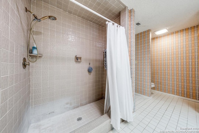 bathroom featuring walk in shower, toilet, tile patterned flooring, and a textured ceiling