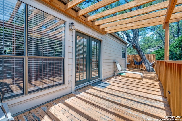 deck featuring french doors and a pergola