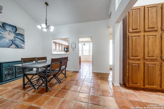 dining room with lofted ceiling, a chandelier, a textured ceiling, and light tile patterned flooring