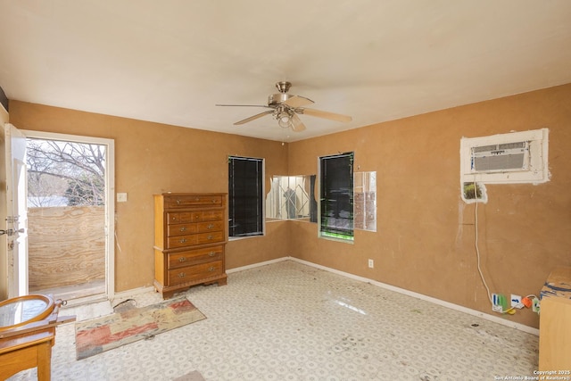 spare room with ceiling fan and an AC wall unit