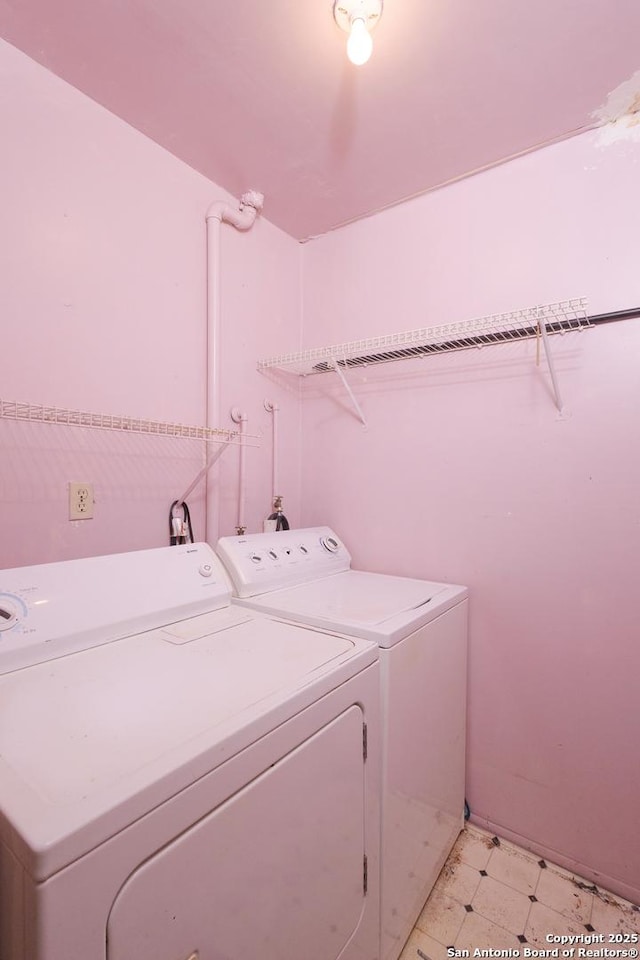 washroom with washing machine and clothes dryer