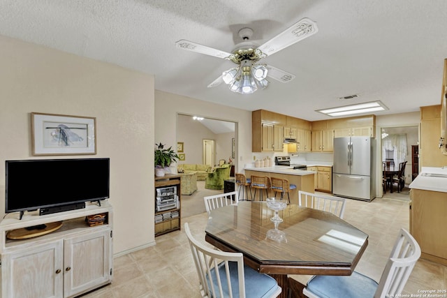 dining room featuring ceiling fan, sink, and a textured ceiling