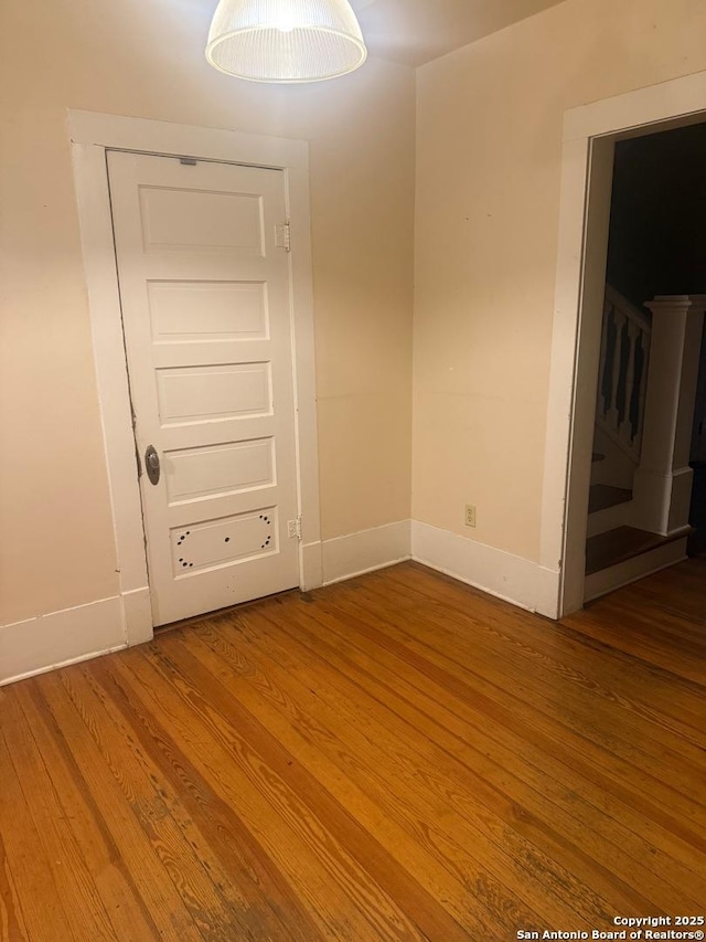 unfurnished room with hardwood / wood-style floors